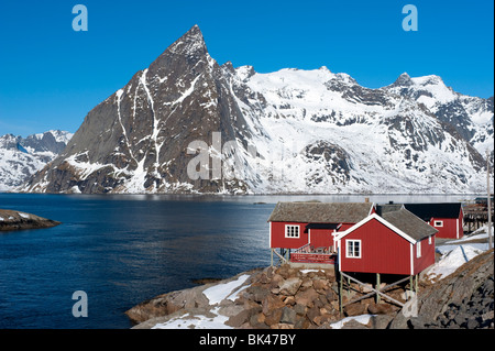 Traditional red wooden Rorbu fishermen`s huts in village of Hamnoy on Moskenesoya Island in Lofoten Islands in Norway Stock Photo